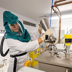 Researcher in safety hood working in a materials laboratory