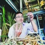 Biofuel researcher with bagasse and biofuel sample