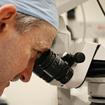 Wesley Research Institute researcher using a microscope