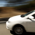 Blurred image of part of a speeding car