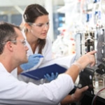Two researchers at laboratory equipment