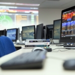 Computer monitors showing financial charts