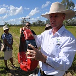 Researcher with a data gathering collar for improved cattle management