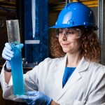 Researcher holding a test tube with blue fluid