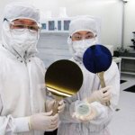 Researcher holding up silicon wafers
